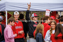 A student makes horns with his hand at the B1G Tailgate for the Nebraska vs UCLA football game. Nove