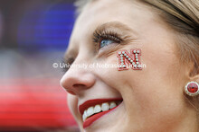 Close up of cheerleader Madi Lundy as she watches the game. Nebraska vs UCLA football game. November