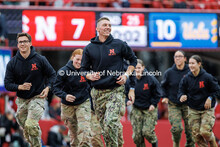 Mitchell Janssen, center, leads the UNL ROTC off the field after completing push-ups. Nebraska vs UC