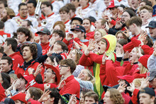 Fans cheer the Huskers during a third down. One fan is dressed as a cob of corn. Nebraska vs UCLA fo