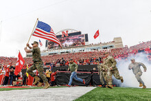 Members of the military run onto the field for Military Appreciation Day. Nebraska vs UCLA football 