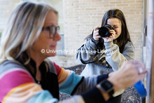 College of Journalism and Mass Communications student Sammy Smith photographs Teresa Ranken as she h