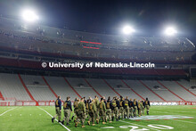 NROTC midshipmen march to the middle of the field. Navy and Marine Corps 249th birthday celebration 