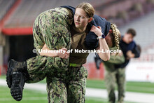 Midshipman Leah Lindhart carries a fellow NROTC member across the field. Navy and Marine Corps 249th