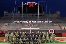 Members of the UNL NROTC pose for a photo on the field. Navy and Marine Corps 249th birthday celebra