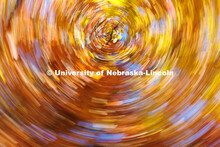 Orange, red, and yellow leaves blend into a vortex near the Nebraska Union in this photo taken at a 