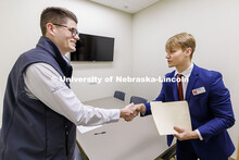 Junior Joshua Buhr, right, shakes hands with alum Parker Merwick during the final round. Fall 2024 C