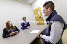 Kylie Eads and Aidan Kelch sell their product to alum Parker Merwick inside the College of Business.