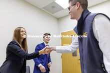 Kylie Eads and Aidan Kelch shakes hands with alum Parker Merwick at the conclusion of their meeting 