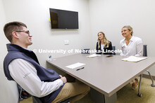 Kate Peterson and Charlie McCown sell their product to alum Parker Merwick inside the College of Bus