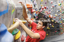 Vitor Lombardi Labegaline, junior, reaches the top of the rock wall in the Campus Recreation facilit