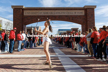 Steffany Lien twirls two batons as fans wait outside the Osborne Legacy Complex for the Husker footb