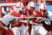 Wide receiver Jacory Barney Jr. (17) has his shirt pulled as he runs after catching the football for