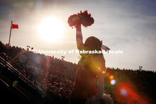 Silhouette of Husker cheerleader cheering at the Huskers vs. Wisconsin football game. November 23, 2