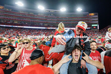 Husker fans storm the field following the team’s 44-25 win over Wisconsin to secure bowl game elig