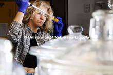 Lauren Moon, a senior in chemistry from Beatrice, pipettes a fluorescent dye. Lauren’s is research