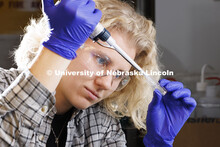 Lauren Moon, a senior in chemistry from Beatrice, pipettes a fluorescent dye. Lauren’s is research