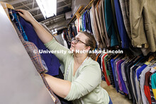 Graduate student Breeanna Pierce looks for the appropriate jacket to use as a costume for a show ins