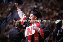 Jonathan Matulka celebrates his College of Education and Human Sciences degree as he walks off stage