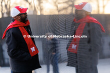 Chancellor Rodney Bennett reads names on the wall of the Vietnam Memorial. Inauguration choir trip. 