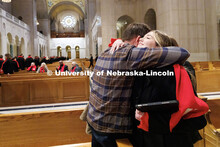 Elly Cheatle, right, hugs her family after performing inside the Basilica of the National Shrine of 