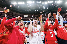 Max Meyer, from left, Logan Eby, and Ryan Eickhoff celebrate as the Nebraska men’s basketball team