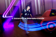 Narayana Pujara, freshman software engineering major, runs around obstacles during a round of laser 