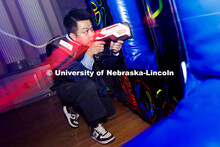 Le Hoang Duc Nguyen aims at an opponent during a round of laser tag inside the Centennial Room of th