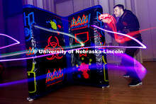 Mark Malmay aims at an opponent during a round of laser tag inside the Centennial Room of the Nebras
