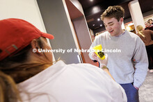 Liam Spieker, senior Advertising and Public Relations major, is given a cup of popcorn during the fi