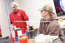 Cory Densberger, a Hospitality Service Associate, talks with Collin Schollmeyer, a junior Business A
