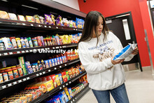 Alex Hazel, freshman Animal Science major, looks at snacks in the aisles of Herbie’s Market inside
