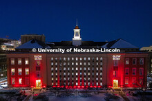 Love Library is lit up in red with gobos projected on the front saying, “Glow Big Red”. Glow Big