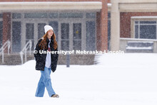 Student crossing campus by the Selleck Quadrangle. Snow on City Campus. February 17, 2025. 