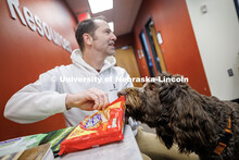 Kenneth Pyle’s dog Jonas attempts to steal a Nutter Butter cookie during his fourth birthday party