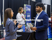 Saicharith Vaitla, a senior Computer Science major, talks to a representative from Gallup. Universit