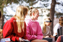 Alpha Chi Omega sisters sit in front of their house together enjoying the warm winter weather. Febru