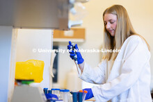 University of Nebraska–Lincoln undergraduate Avery Marquis, poses in lab coat for a photo in Luwen