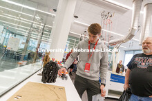 A student examines a printed 3D model car during a lab tour in Kiewit Hall. Admitted Student Day is 
