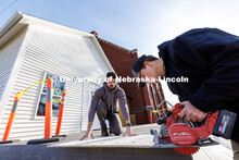 Third year architecture students Ethan Watermeier, right, and Devyn Beekman cut a section off of a p