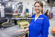 Teresa Monsees, a senior mechanical engineering major, holds the prototype of a robotic hand that wi