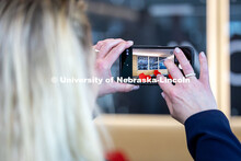 Melissa Brotz Chief Marketing and Communications Officer of Abbott, takes a photo of the wall that d