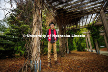 Caden Simon poses for a portrait under the vine arbor in the University of Nebraska–Lincoln's Maxw