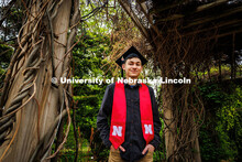 Caden Simon poses for a portrait under the vine arbor in the University of Nebraska–Lincoln's Maxw