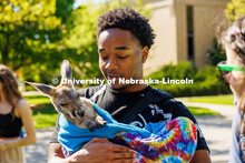 Lincoln Washington, a sophomore sports media and communication major, holds a joey from Wildlife Enc
