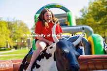 Amanda Courtney, a junior music education major, rides the mechanical bull at the End of Year Bash o