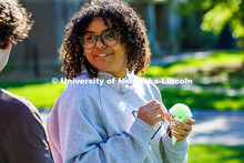 A UNL student talks to her friend after getting a snow cone at the End of Year Bash on East Campus. 