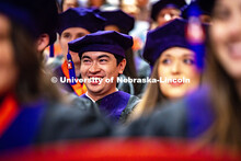 Keegan Huffman laughs while listening to Robert Denicola, a Law Emeritus professor, speak to the gra