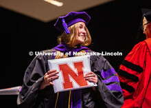 Abigail Bennetts smiles at her family members in the crowd after receiving her diploma and hood. 202