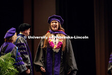 A law graduate crosses the stage at the 2025 College of Law commencement in the Lied Center. May 3, 